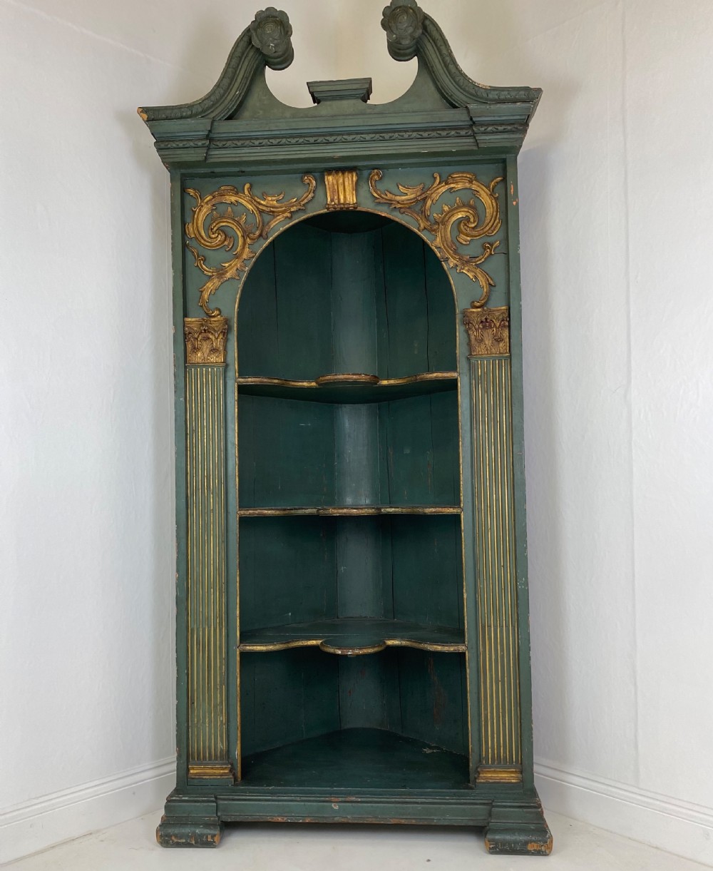 An 18th-century floor-standing teal green open corner cupboard featuring gold leaf detailing, fluted pilasters, and a broken swan-neck pediment. View VII