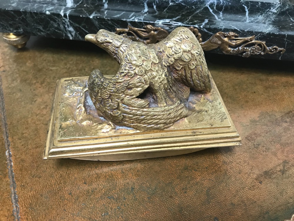 A French gilt bronze eagle sculpture mounted on a black marble base with two lidded ink pots, a pen recess, and an accompanying rocker blotter. View VI