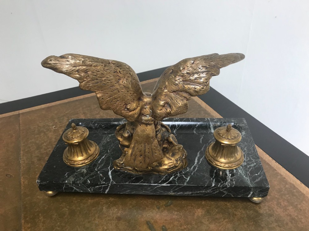 A French gilt bronze eagle sculpture mounted on a black marble base with two lidded ink pots, a pen recess, and an accompanying rocker blotter. View VII