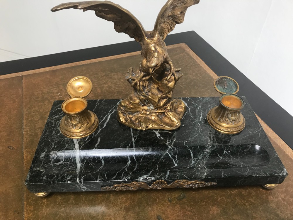 A French gilt bronze eagle sculpture mounted on a black marble base with two lidded ink pots, a pen recess, and an accompanying rocker blotter. View VIII