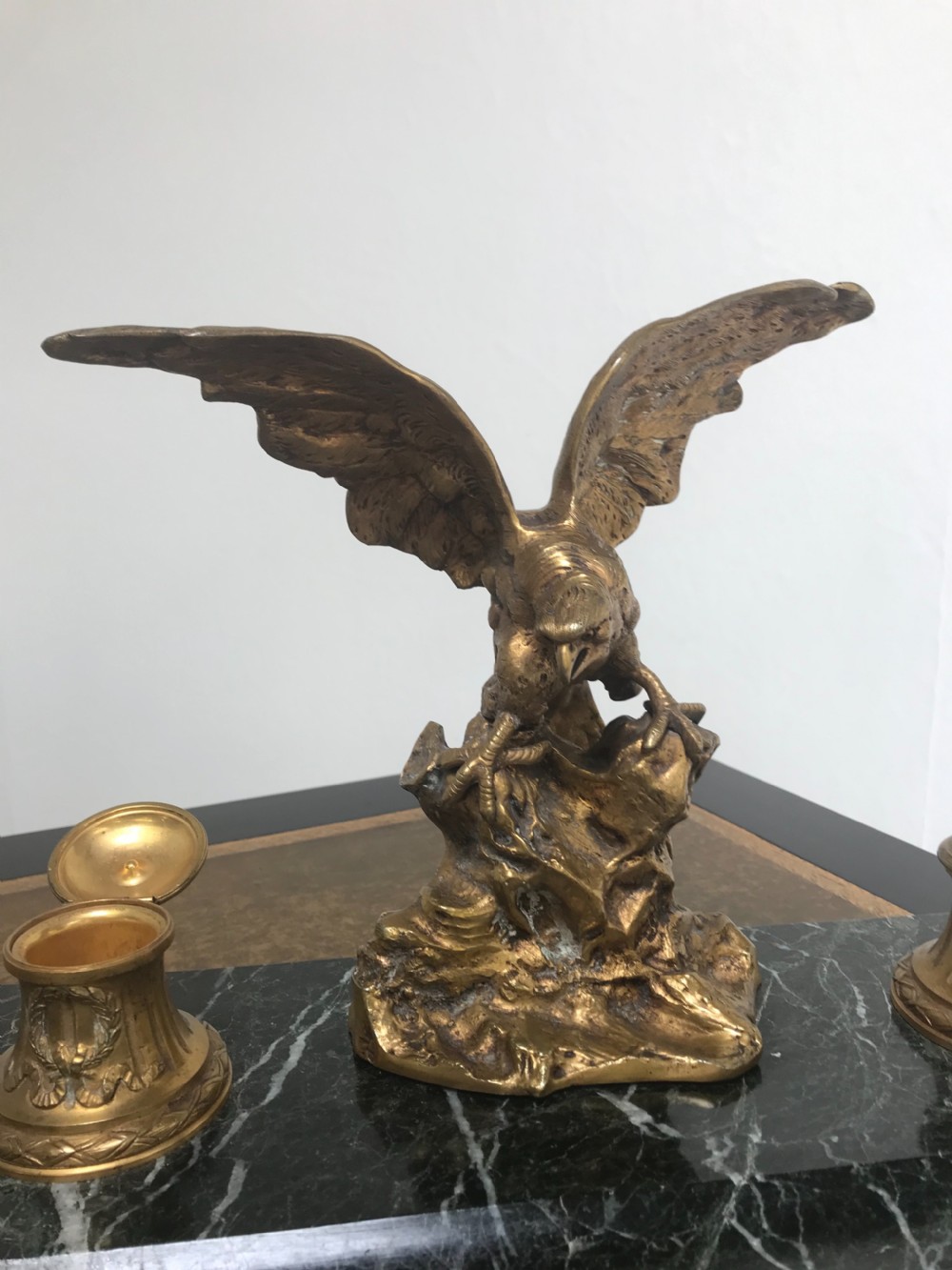 A French gilt bronze eagle sculpture mounted on a black marble base with two lidded ink pots, a pen recess, and an accompanying rocker blotter. View X