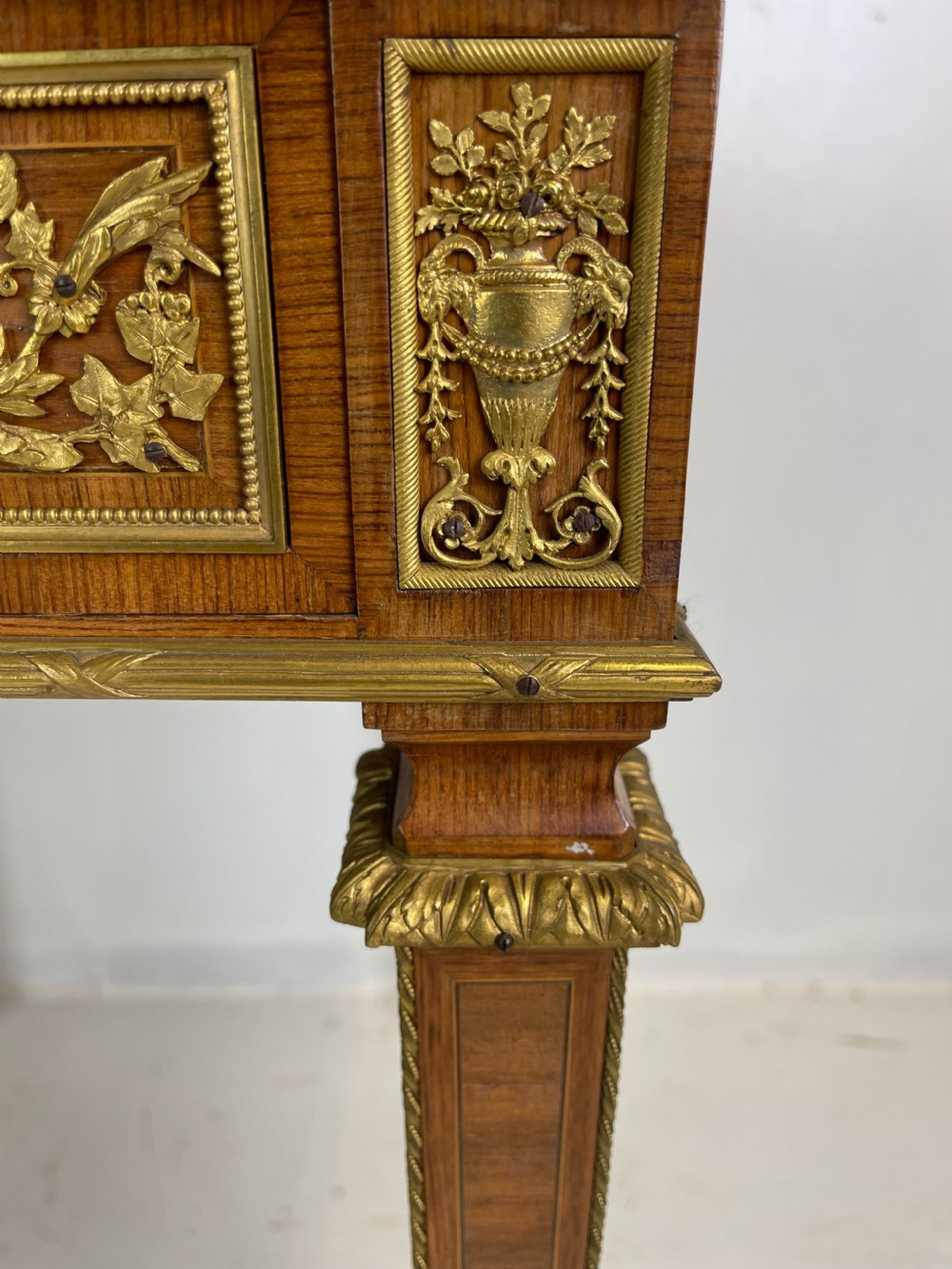 A square French Louis XVI style parquetry envelope card table featuring detailed gilt-bronze mounts and tapered legs. View II