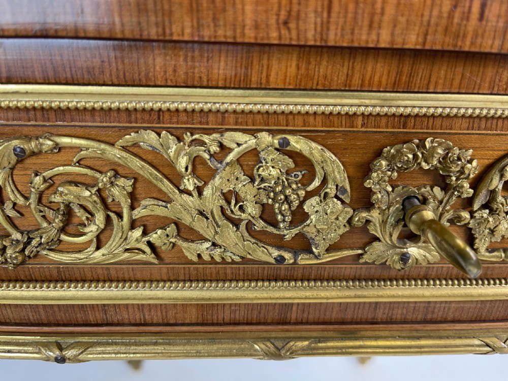 A square French Louis XVI style parquetry envelope card table featuring detailed gilt-bronze mounts and tapered legs. View III