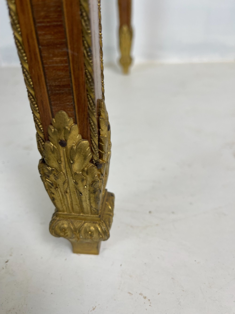A square French Louis XVI style parquetry envelope card table featuring detailed gilt-bronze mounts and tapered legs. View IV