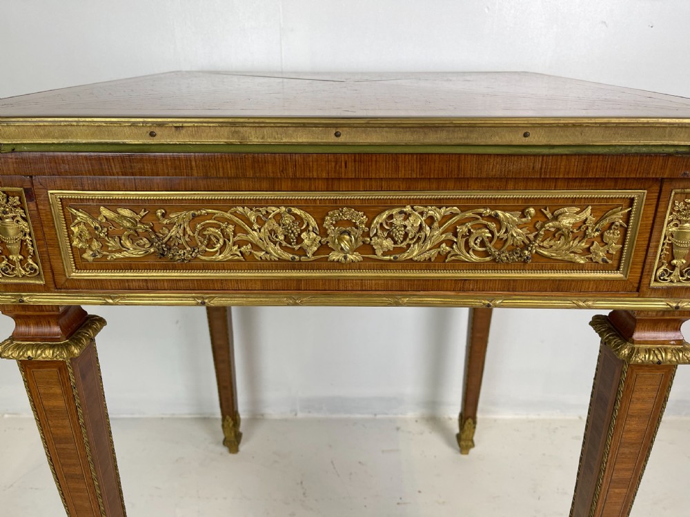 A square French Louis XVI style parquetry envelope card table featuring detailed gilt-bronze mounts and tapered legs. View V