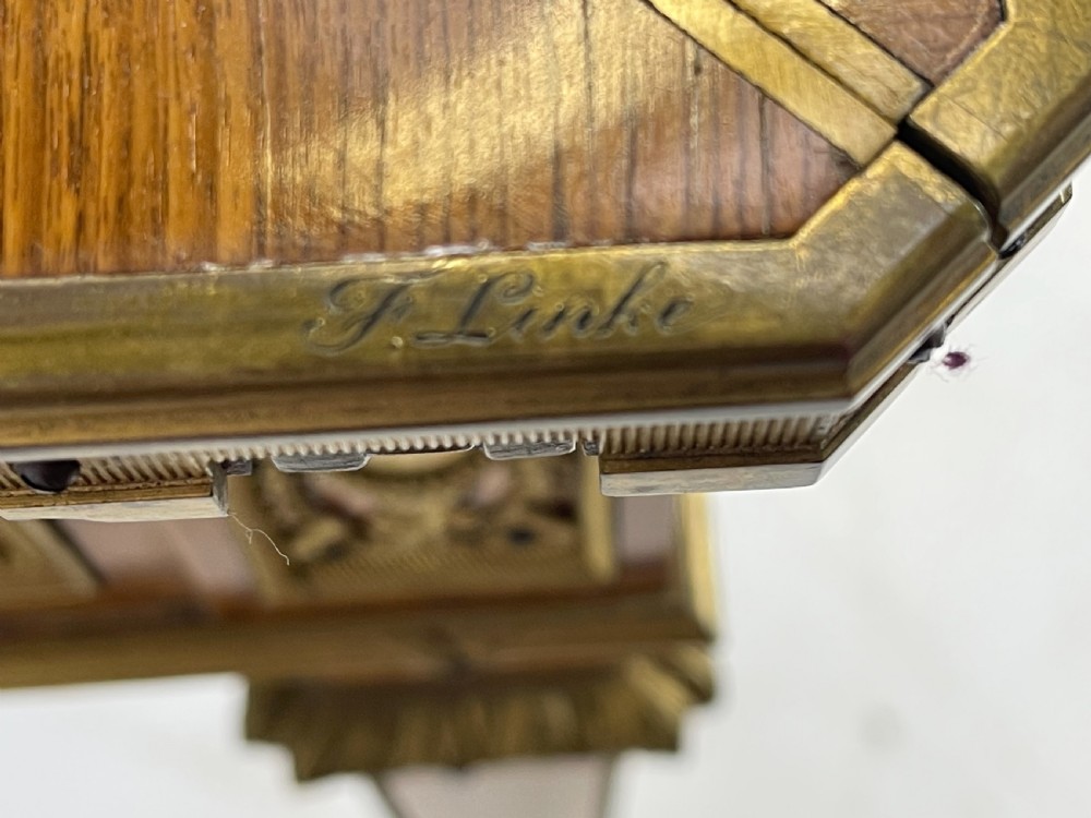 A square French Louis XVI style parquetry envelope card table featuring detailed gilt-bronze mounts and tapered legs. View VI