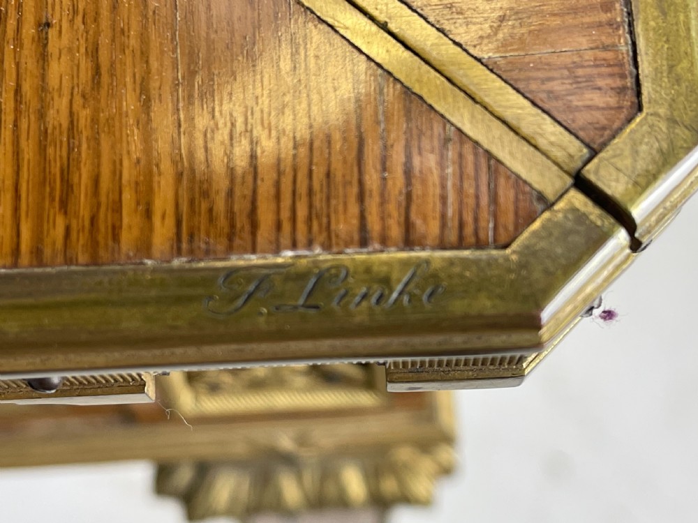 A square French Louis XVI style parquetry envelope card table featuring detailed gilt-bronze mounts and tapered legs. View VIII