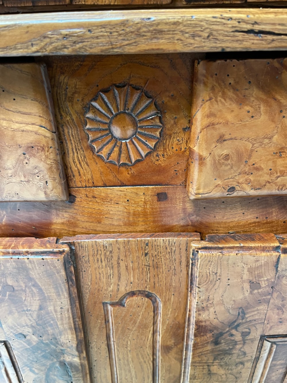 An antique two-piece French walnut cabinet featuring carved floral crests, molded panel doors, two drawers, and short cabriole feet. View IX