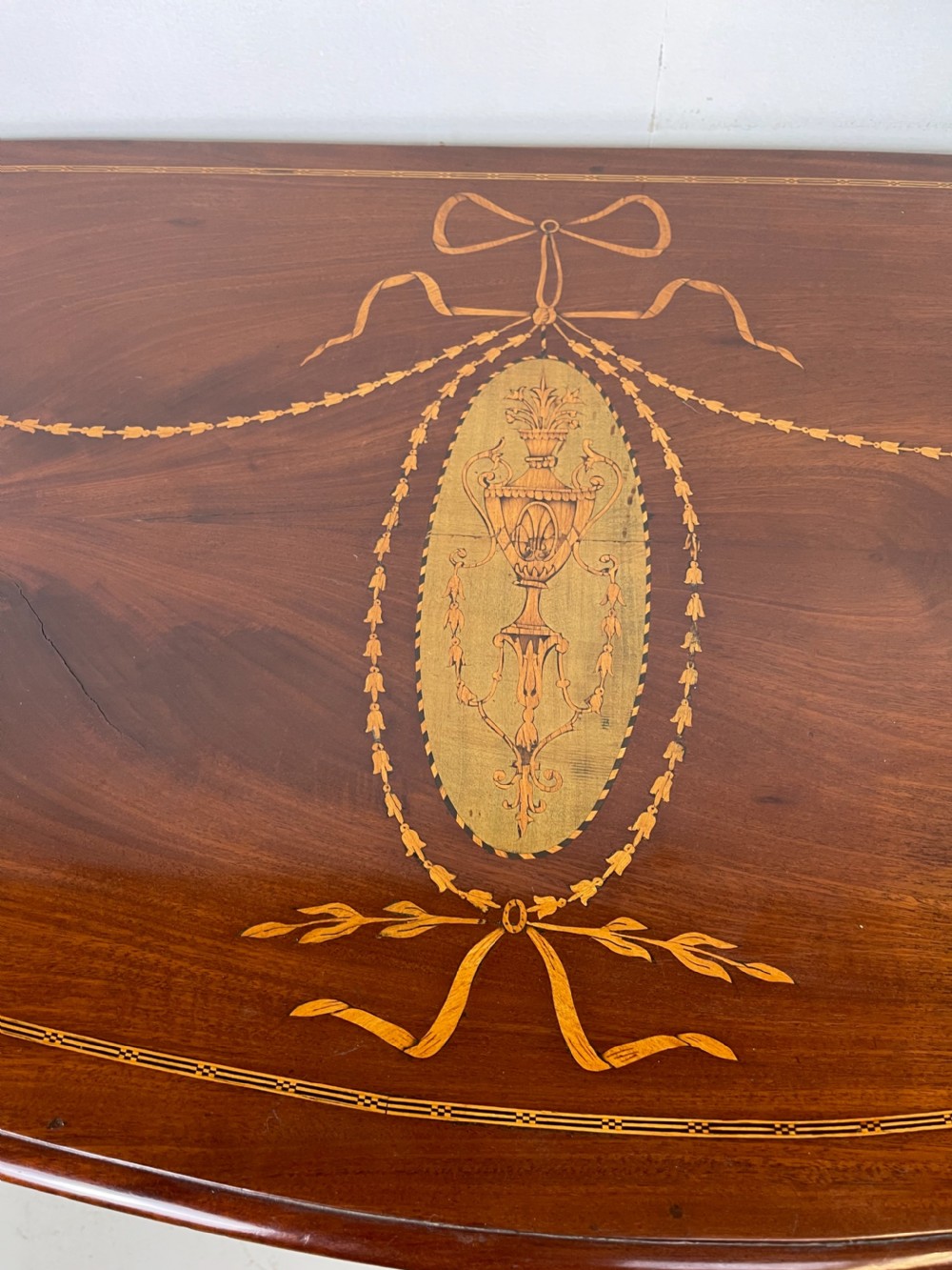 An 18th-century French walnut commode featuring three drawers with elaborate fruitwood marquetry inlays, cast brass escutcheons, and curved cabriole legs. View VII