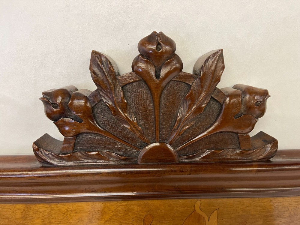 An Art Nouveau wooden bed frame featuring floral marquetry inlay on the headboard and footboard with carved organic scrollwork. View VII