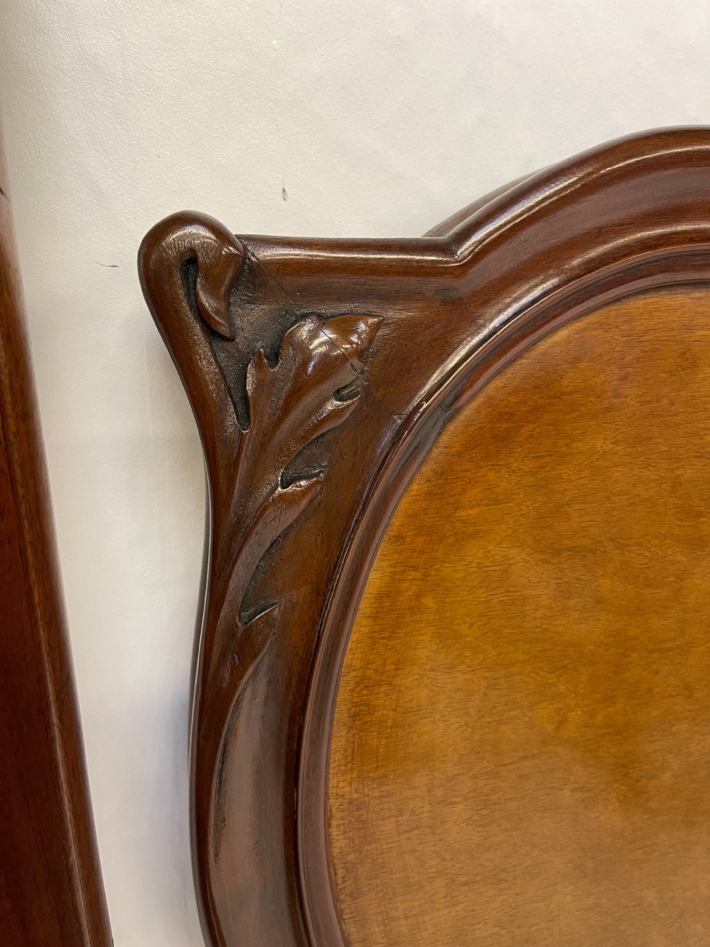 An Art Nouveau wooden bed frame featuring floral marquetry inlay on the headboard and footboard with carved organic scrollwork. View VIII