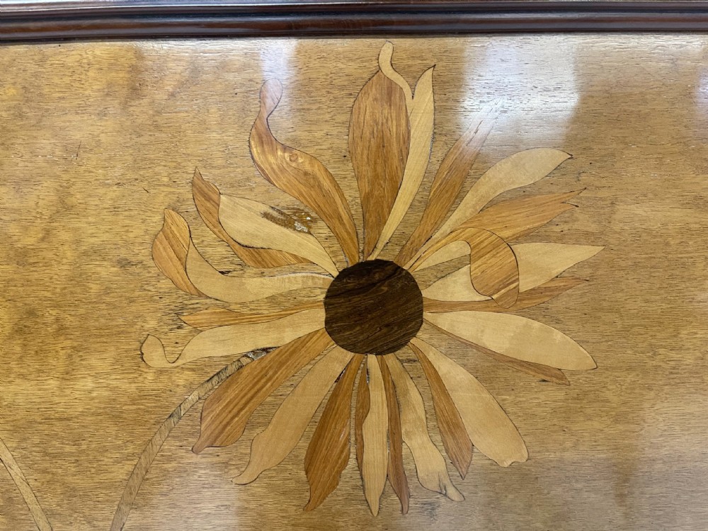 An Art Nouveau wooden bed frame featuring floral marquetry inlay on the headboard and footboard with carved organic scrollwork. View X