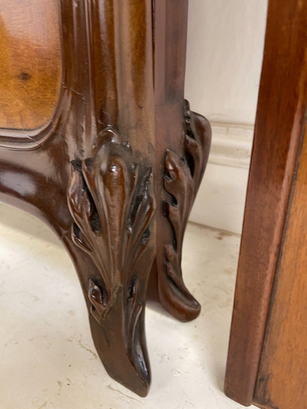 An Art Nouveau wooden bed frame featuring floral marquetry inlay on the headboard and footboard with carved organic scrollwork. View XII