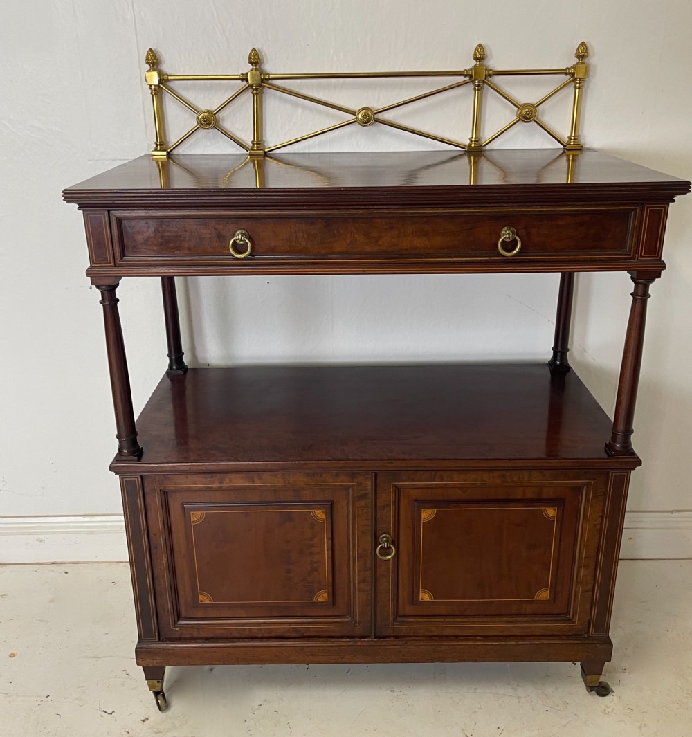An inlaid mahogany sideboard and matching serving table featuring brass gallery rails and satinwood fan marquetry. View II