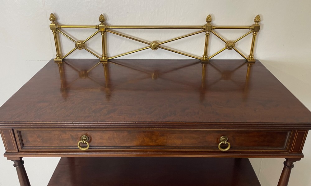 An inlaid mahogany sideboard and matching serving table featuring brass gallery rails and satinwood fan marquetry. View III