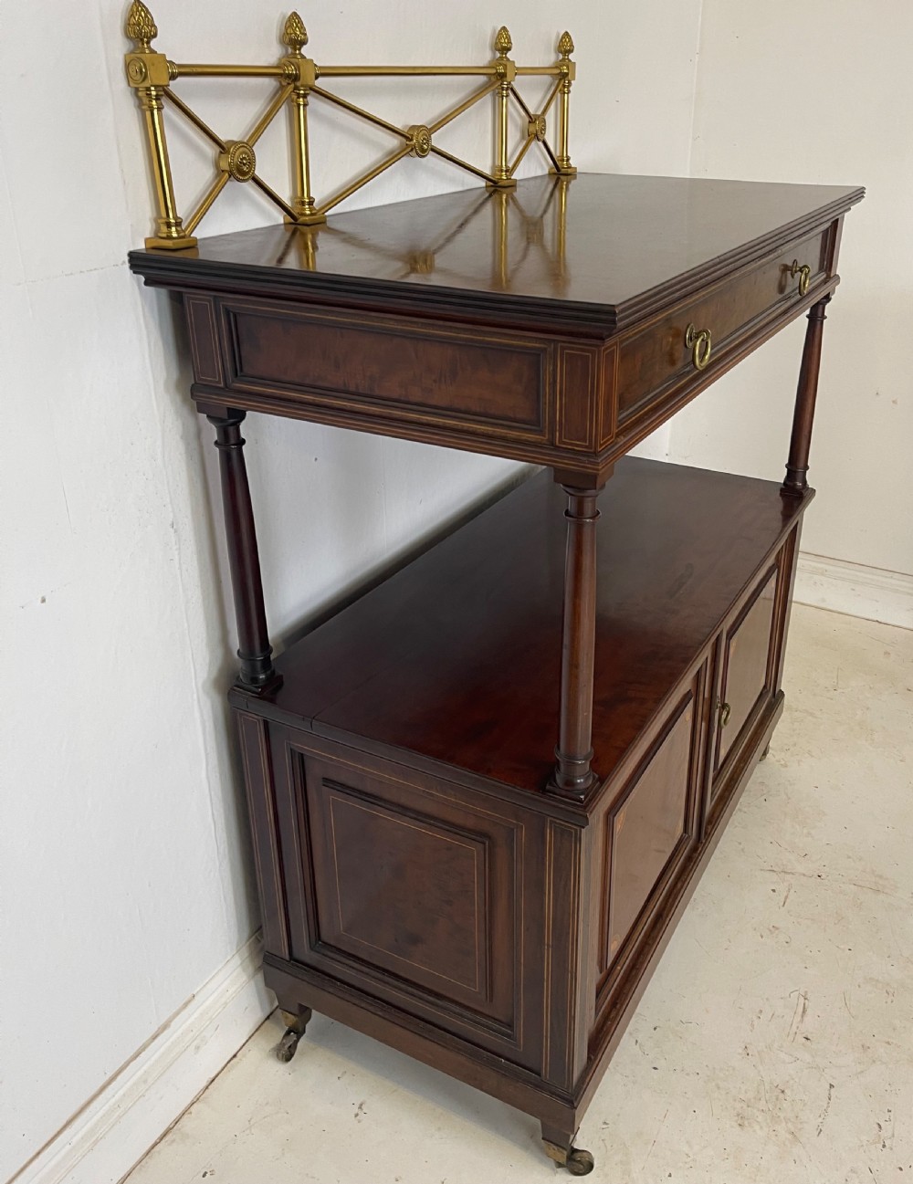 An inlaid mahogany sideboard and matching serving table featuring brass gallery rails and satinwood fan marquetry. View VII