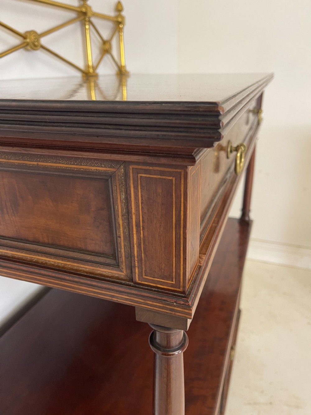 An inlaid mahogany sideboard and matching serving table featuring brass gallery rails and satinwood fan marquetry. View VIII