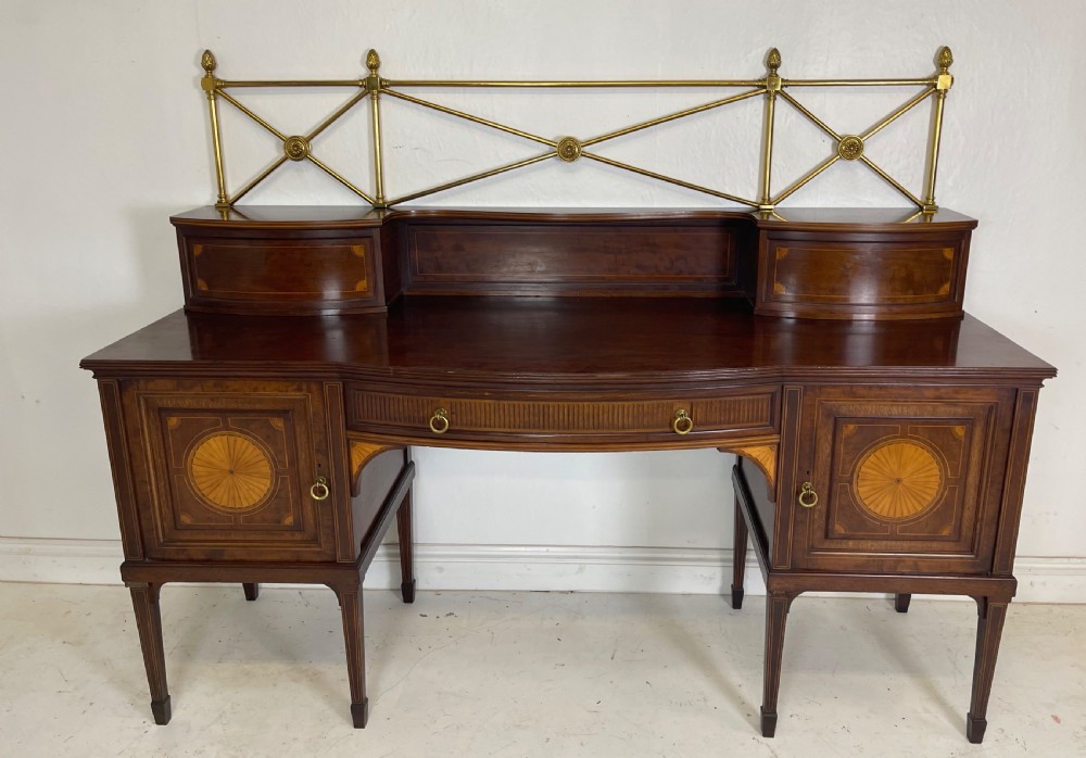 An inlaid mahogany sideboard and matching serving table featuring brass gallery rails and satinwood fan marquetry. View XI