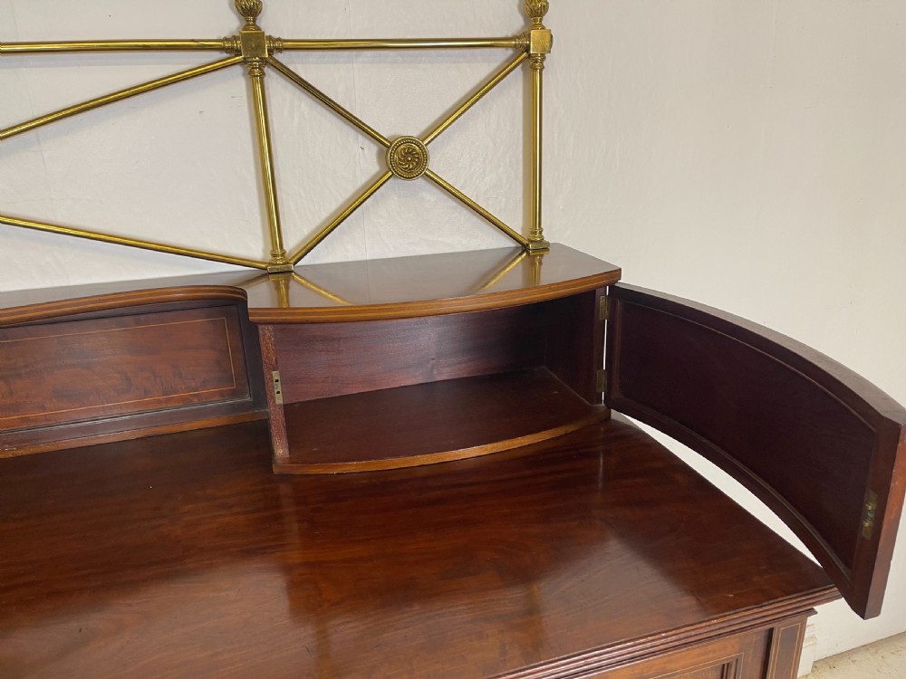 An inlaid mahogany sideboard and matching serving table featuring brass gallery rails and satinwood fan marquetry. View XIV