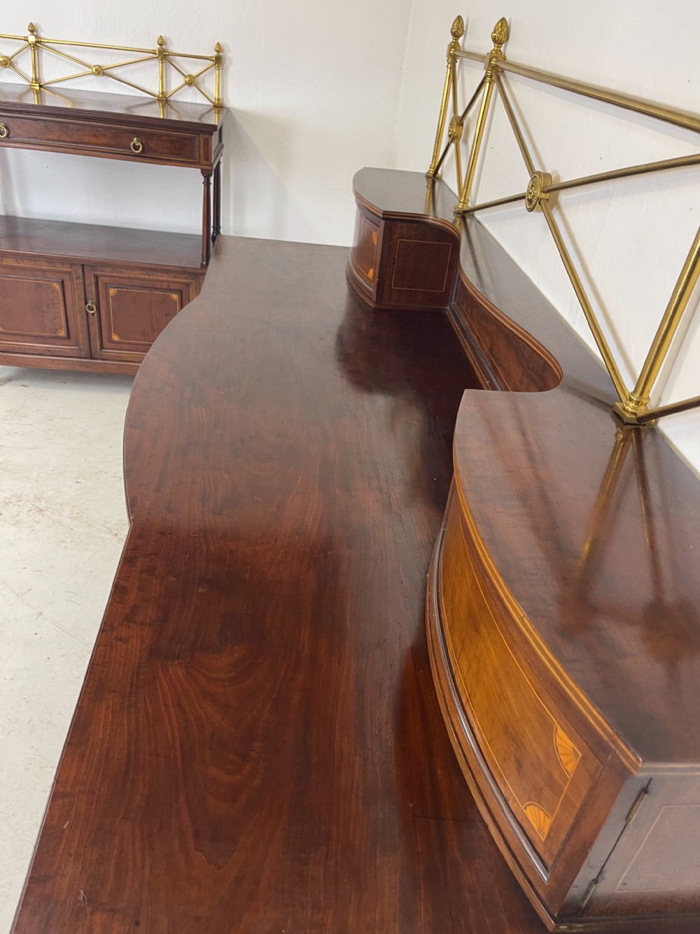 An inlaid mahogany sideboard and matching serving table featuring brass gallery rails and satinwood fan marquetry. View XX