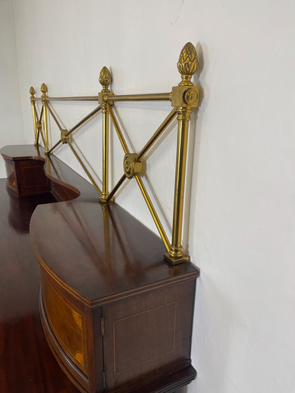 An inlaid mahogany sideboard and matching serving table featuring brass gallery rails and satinwood fan marquetry. View XXI
