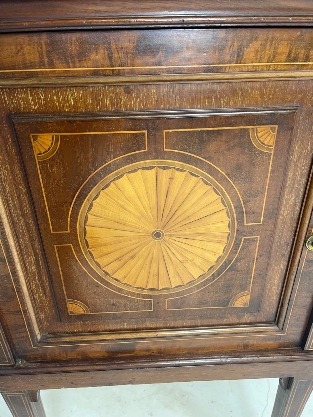 An inlaid mahogany sideboard and matching serving table featuring brass gallery rails and satinwood fan marquetry. View XXIII
