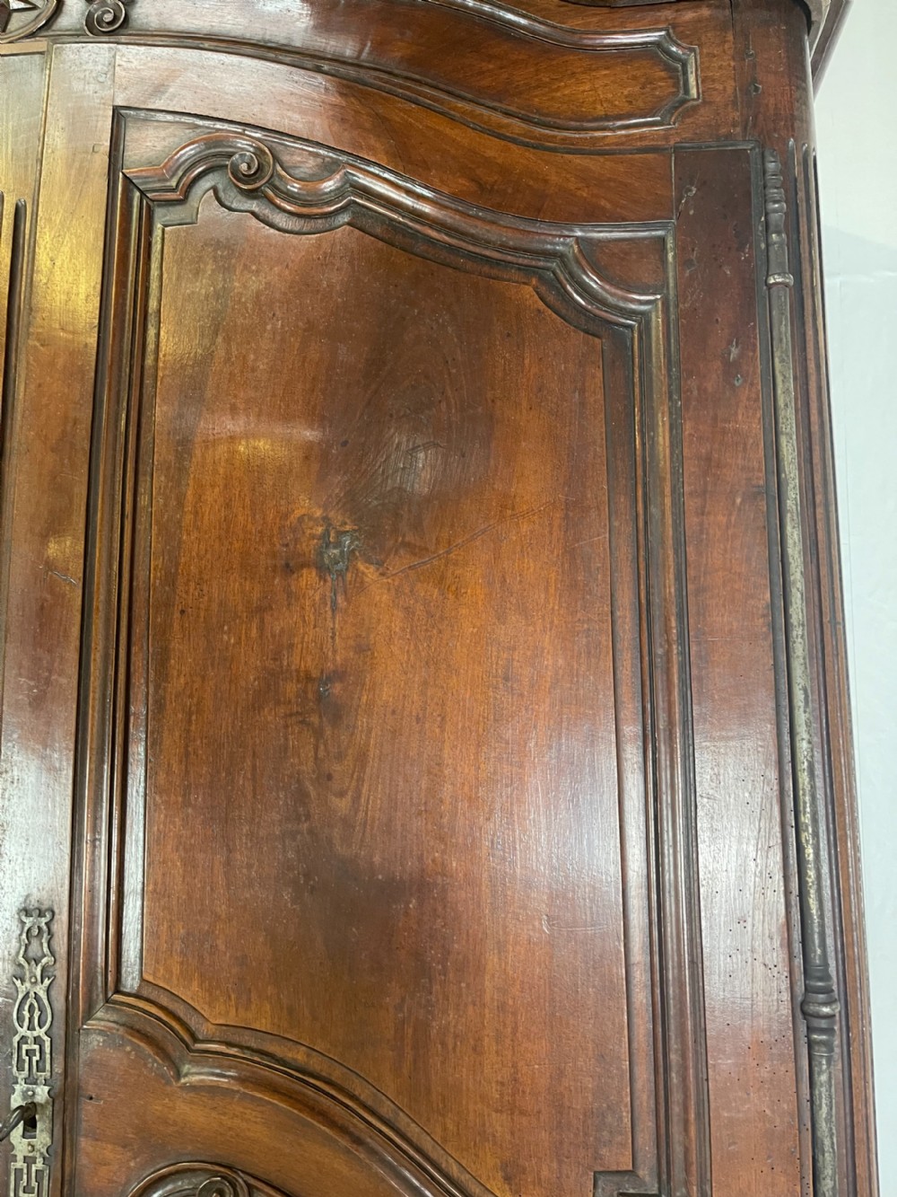 An antique French provincial walnut buffet deux corps featuring two upper panelled doors under a shaped cornice, two lower drawers, and carved cupboard doors resting on short cabriole feet. View II