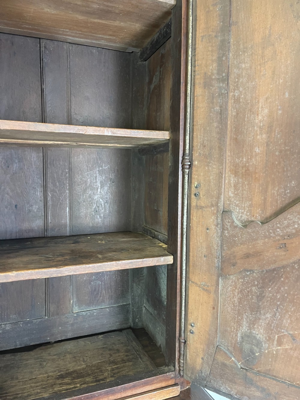 An antique French provincial walnut buffet deux corps featuring two upper panelled doors under a shaped cornice, two lower drawers, and carved cupboard doors resting on short cabriole feet. View VII