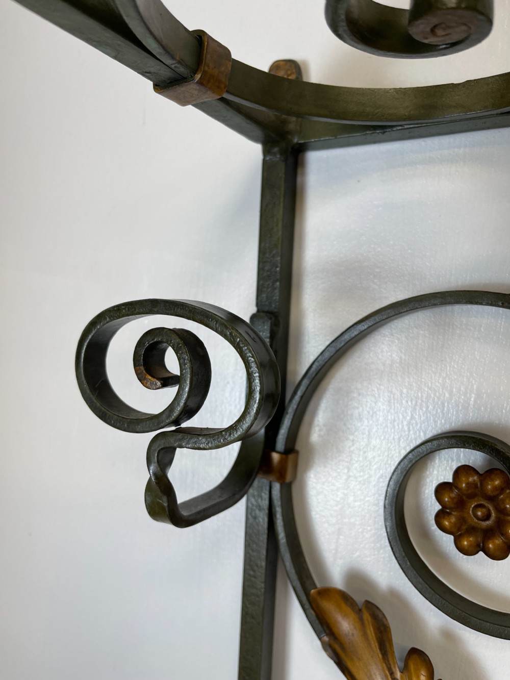 A tall French Art Deco wrought iron hall stand featuring symmetrical scrollwork with gold leaf accents, a central full-length mirror, multiple hooks, and umbrella drip trays. View IV