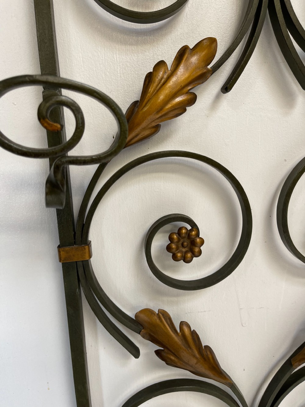 A tall French Art Deco wrought iron hall stand featuring symmetrical scrollwork with gold leaf accents, a central full-length mirror, multiple hooks, and umbrella drip trays. View IX