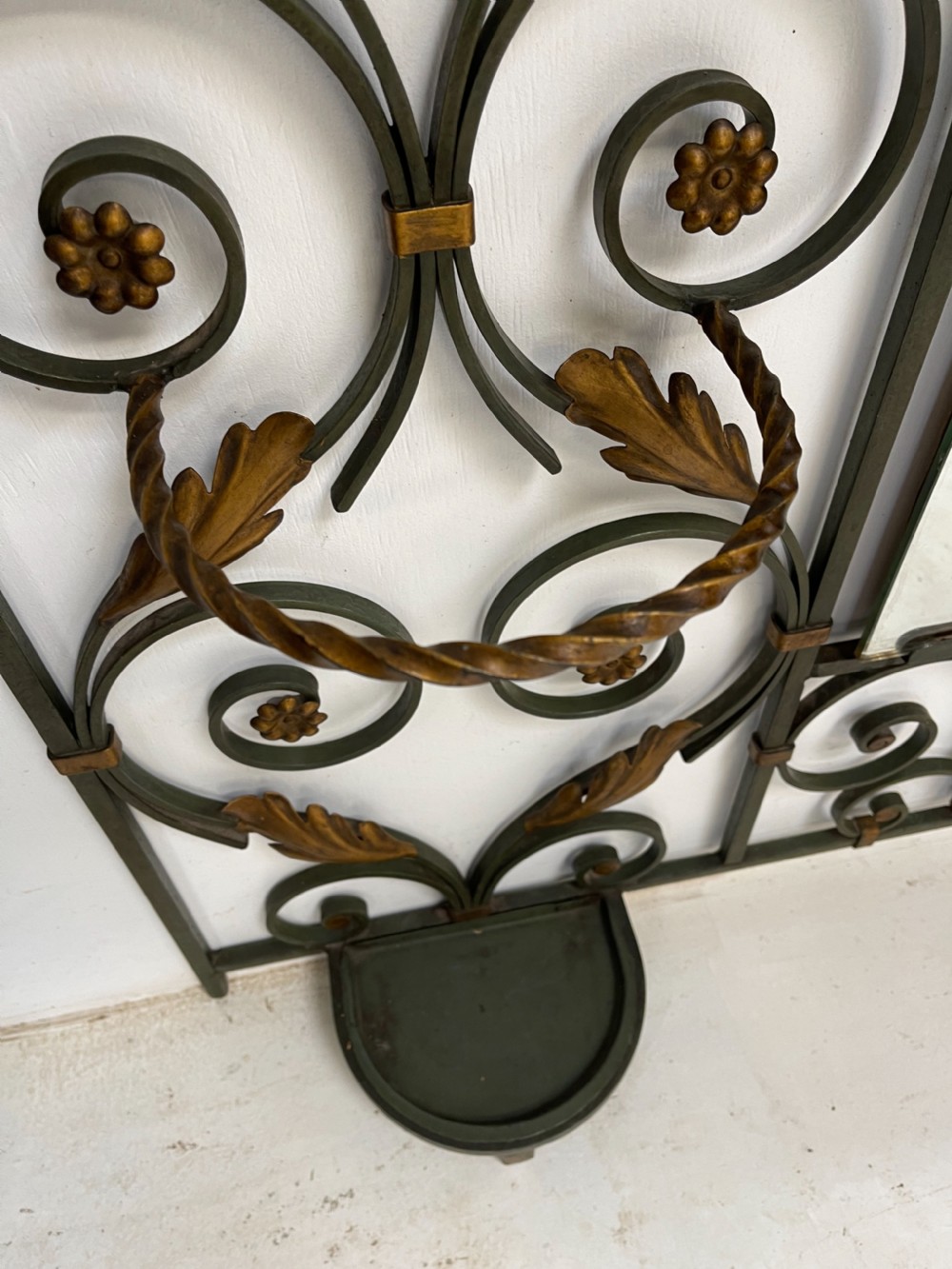 A tall French Art Deco wrought iron hall stand featuring symmetrical scrollwork with gold leaf accents, a central full-length mirror, multiple hooks, and umbrella drip trays. View XI
