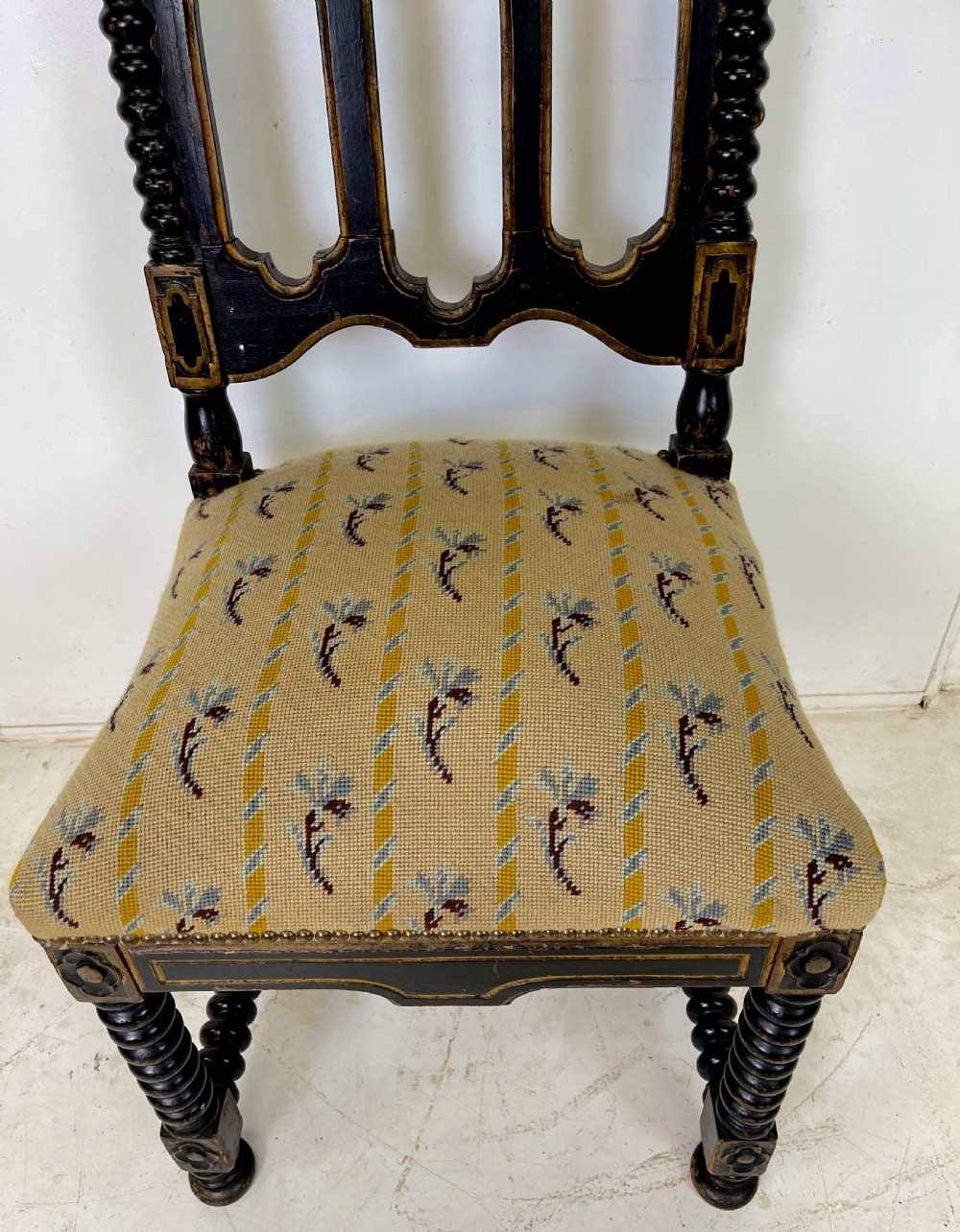A Victorian Gothic Revival side chair featuring an ebonised frame with lancet arch tracery, bobbin turned legs, and patterned cream upholstery with brass stud details. View III