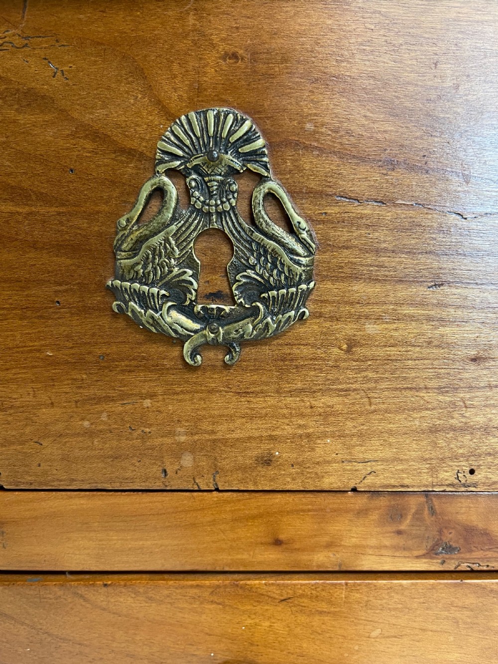 A tall French cherrywood semainier featuring seven drawers with brass drop handles and decorative keyhole escutcheons. View VIII