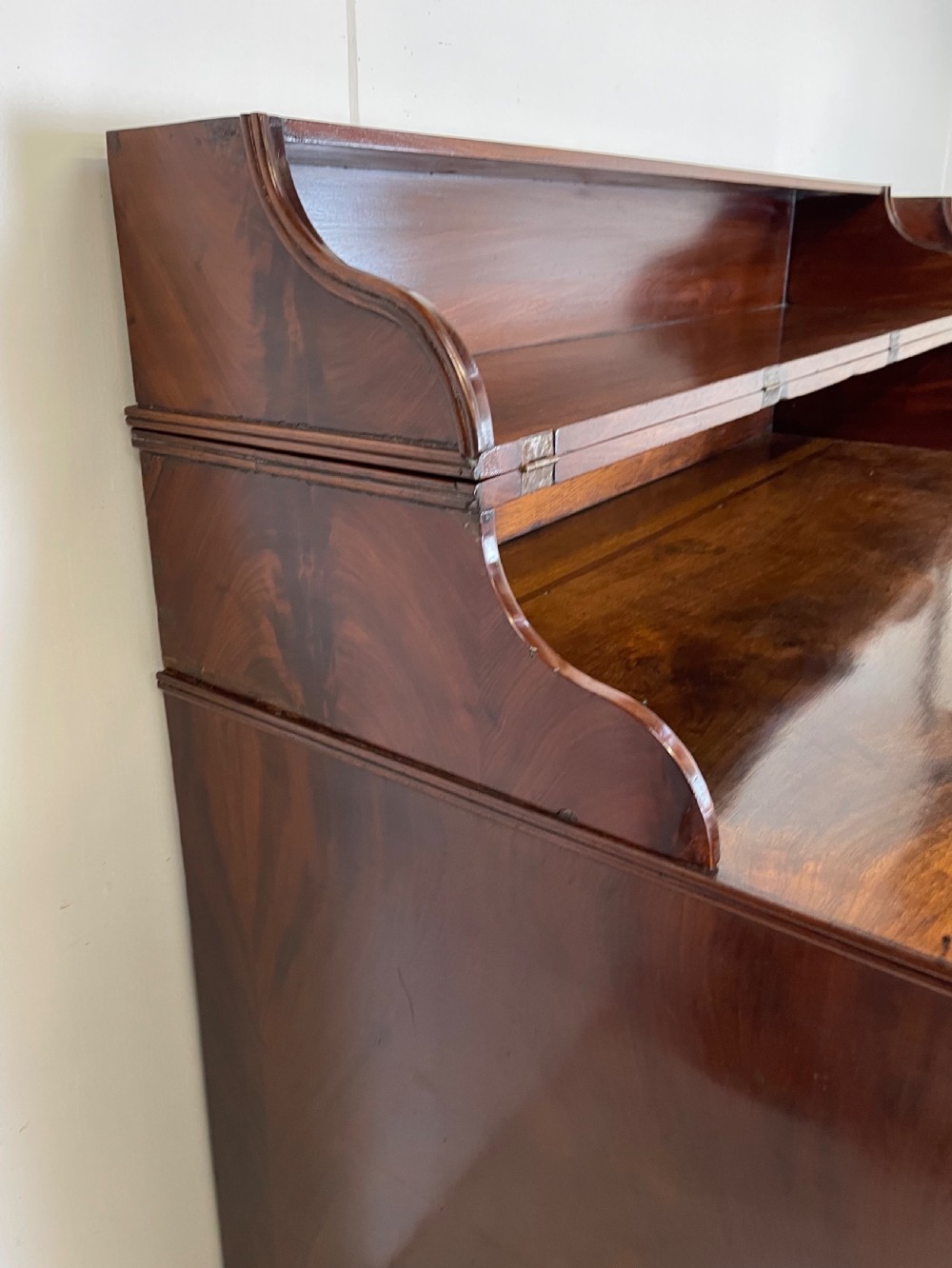 A pair of mahogany serving cupboards with flame veneer doors and folding upper gallery shelves. View X