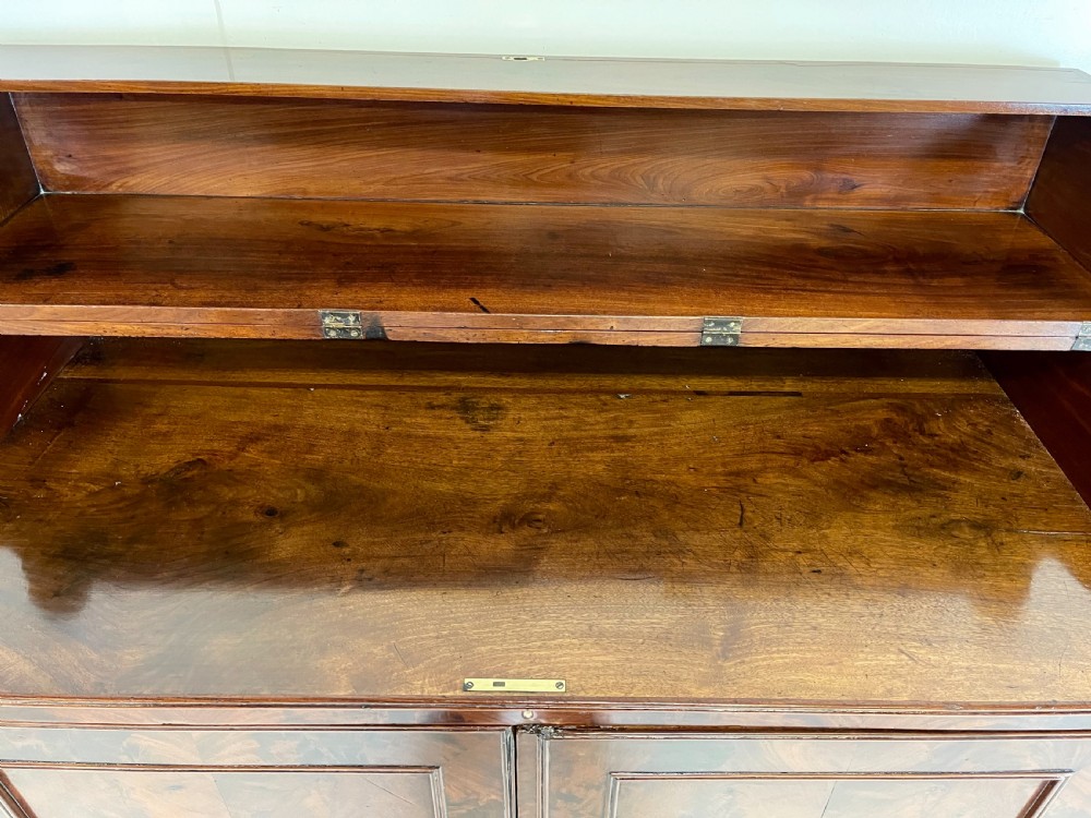 A pair of mahogany serving cupboards with flame veneer doors and folding upper gallery shelves. View XII