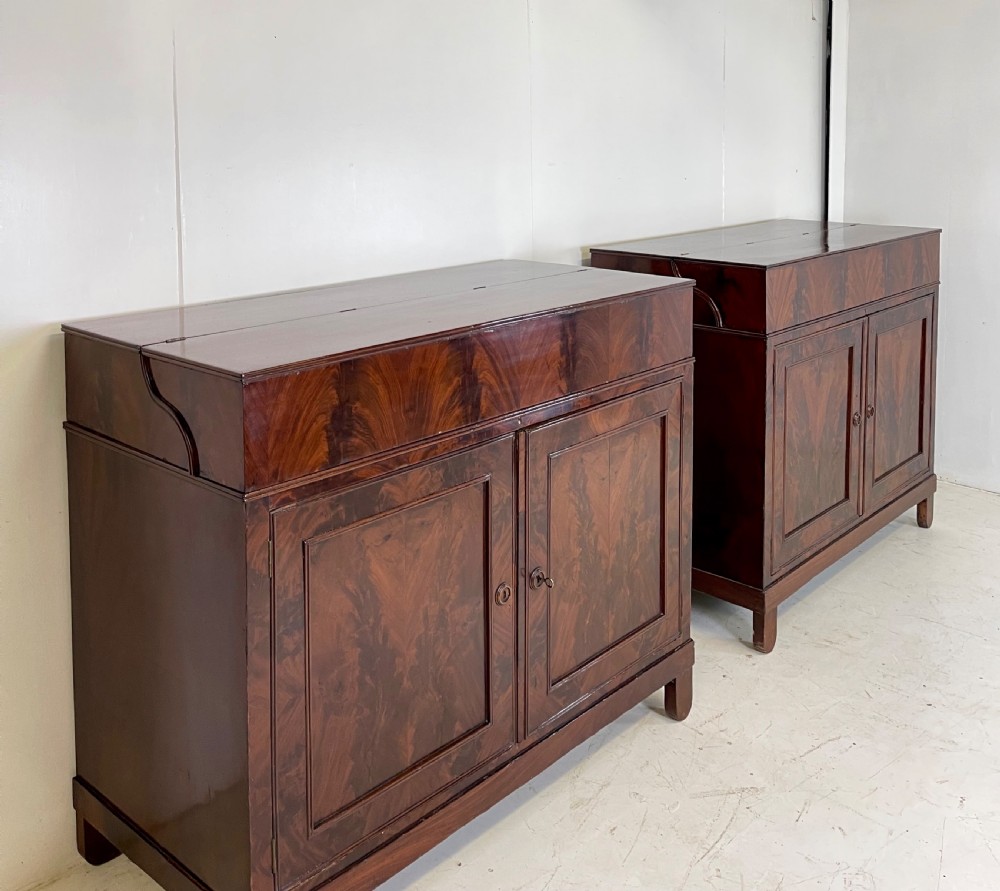 A pair of mahogany serving cupboards with flame veneer doors and folding upper gallery shelves. View XIII
