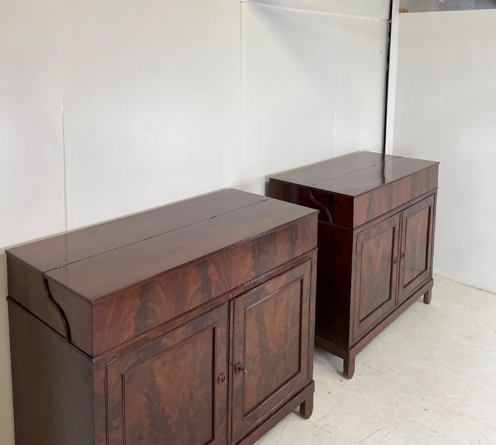 A pair of mahogany serving cupboards with flame veneer doors and folding upper gallery shelves. View XIV