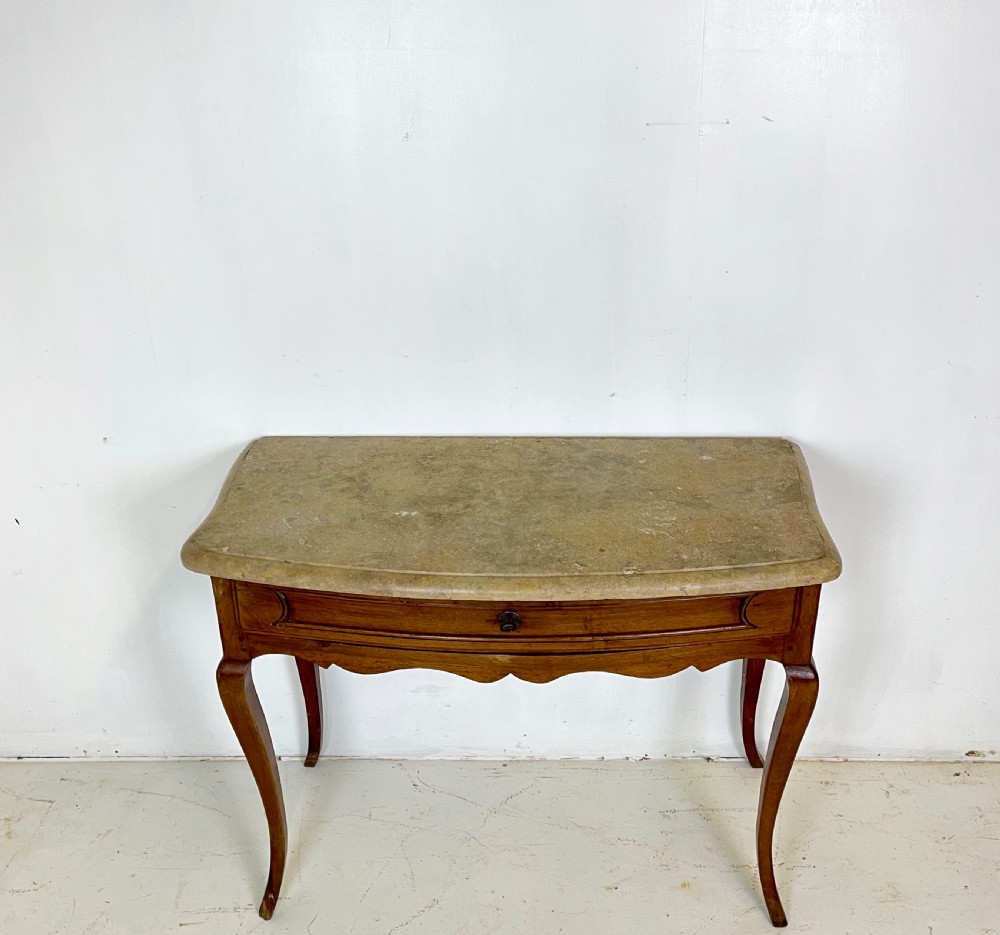 An antique French Provincial side table featuring a grey marble top, a single drawer with a carved apron, and slender cabriole legs. View II