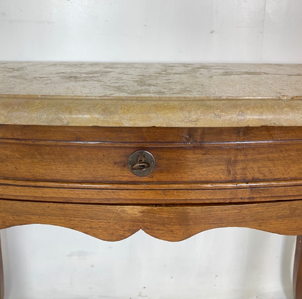 An antique French Provincial side table featuring a grey marble top, a single drawer with a carved apron, and slender cabriole legs. View V