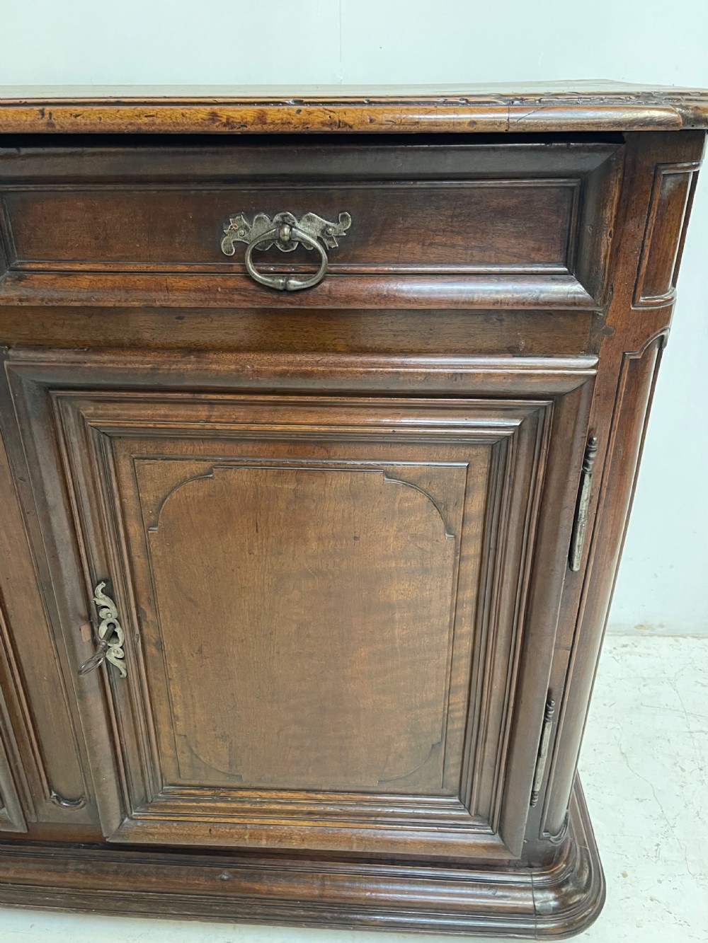 An antique French walnut buffet featuring two top drawers above two moulded panel cupboard doors with iron hardware and a solid plinth base. View III