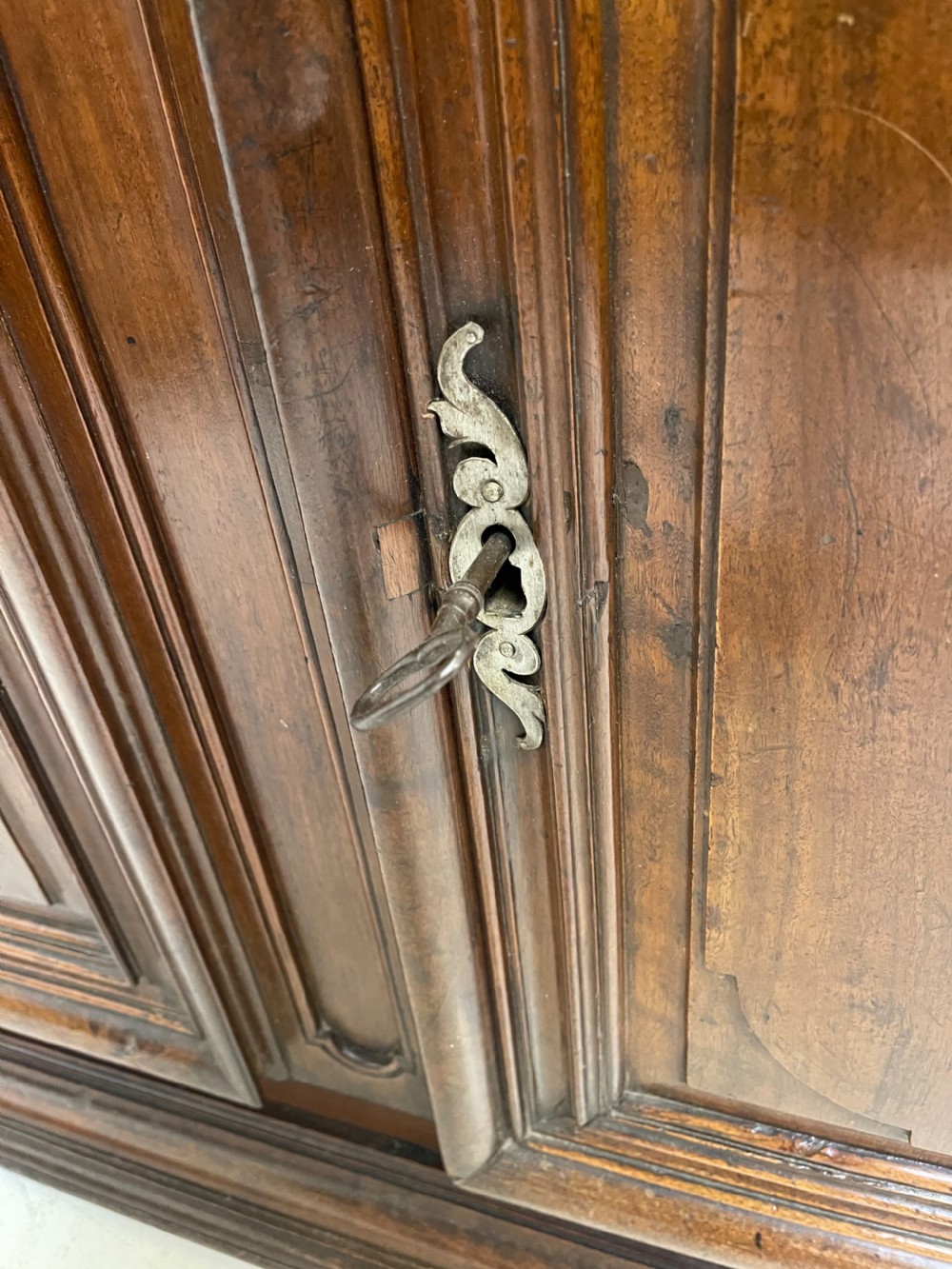 An antique French walnut buffet featuring two top drawers above two moulded panel cupboard doors with iron hardware and a solid plinth base. View VI