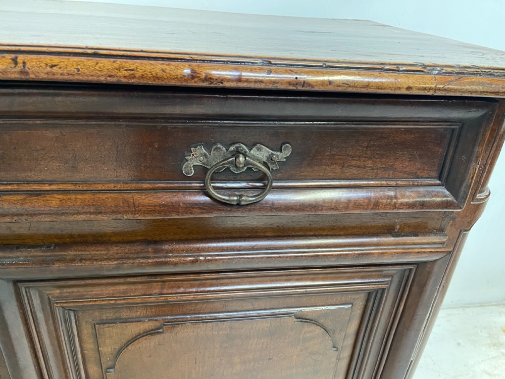 An antique French walnut buffet featuring two top drawers above two moulded panel cupboard doors with iron hardware and a solid plinth base. View VII