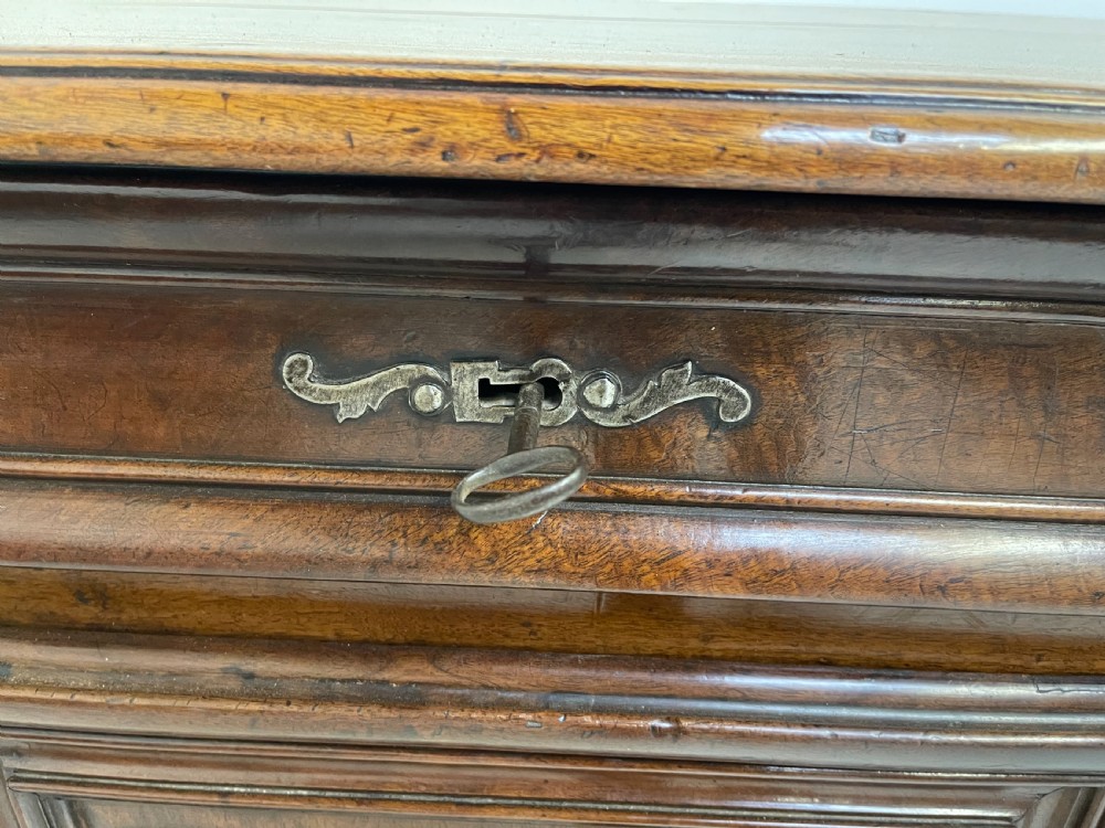 An antique French walnut buffet featuring two top drawers above two moulded panel cupboard doors with iron hardware and a solid plinth base. View VIII