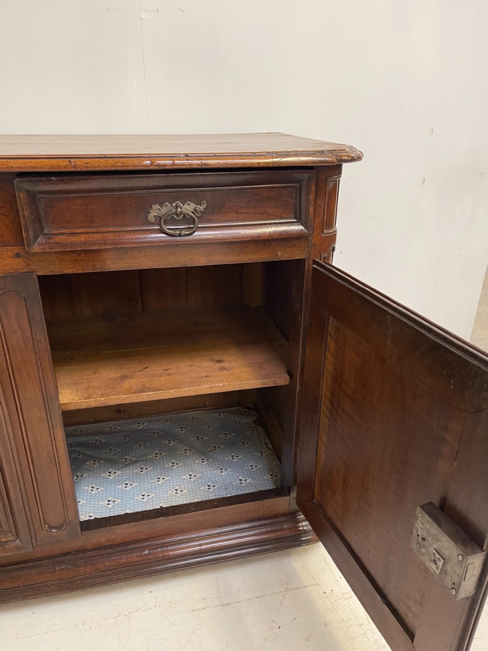 An antique French walnut buffet featuring two top drawers above two moulded panel cupboard doors with iron hardware and a solid plinth base. View IX