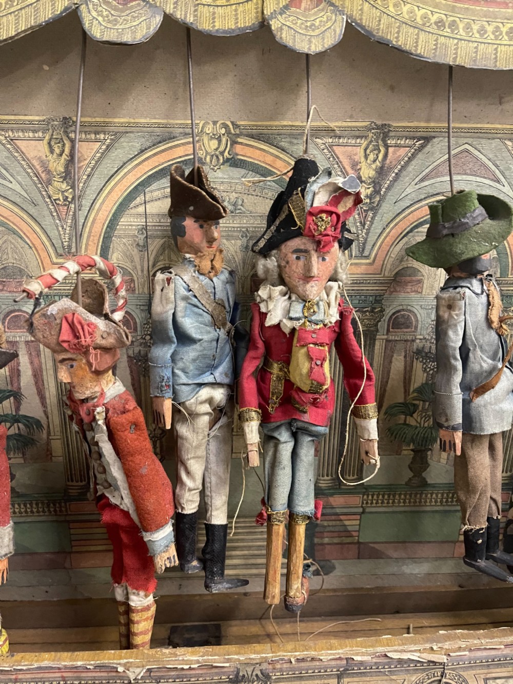 An antique wooden and paper toy puppet theatre labelled Opera, featuring miniature costumed marionettes on a painted classical stage. View VIII