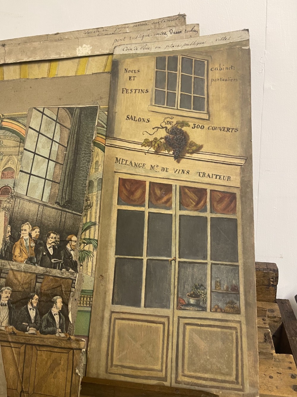 An antique wooden and paper toy puppet theatre labelled Opera, featuring miniature costumed marionettes on a painted classical stage. View XIV