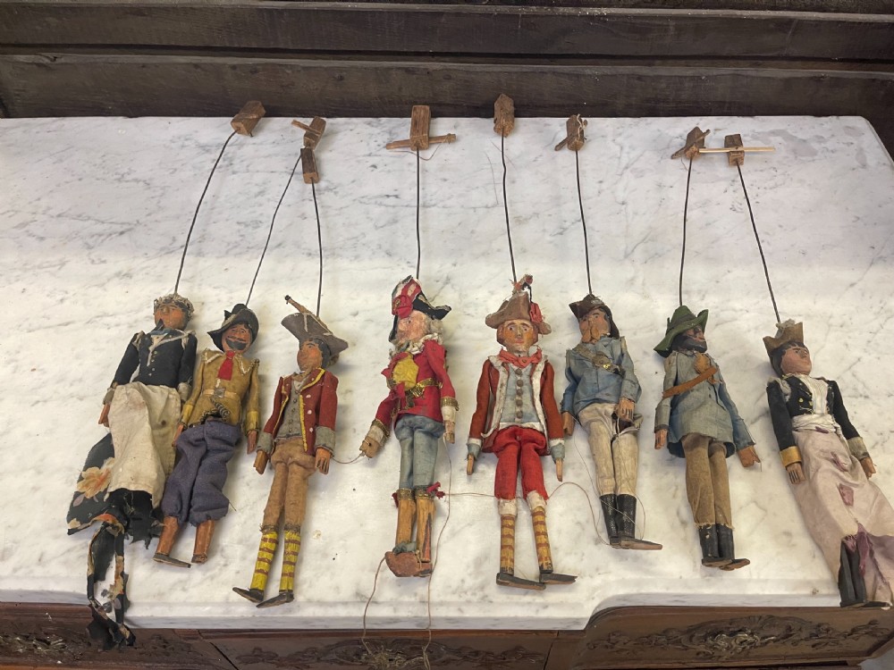 An antique wooden and paper toy puppet theatre labelled Opera, featuring miniature costumed marionettes on a painted classical stage. View XV
