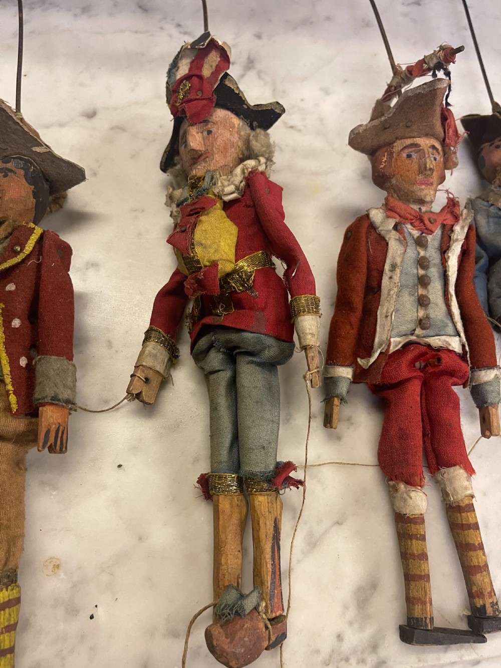 An antique wooden and paper toy puppet theatre labelled Opera, featuring miniature costumed marionettes on a painted classical stage. View XX