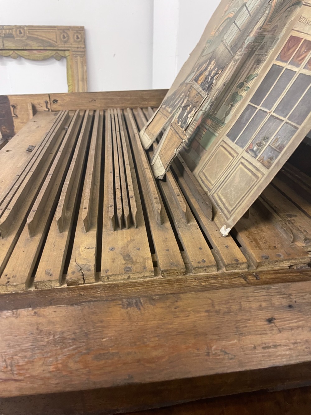An antique wooden and paper toy puppet theatre labelled Opera, featuring miniature costumed marionettes on a painted classical stage. View XXIII