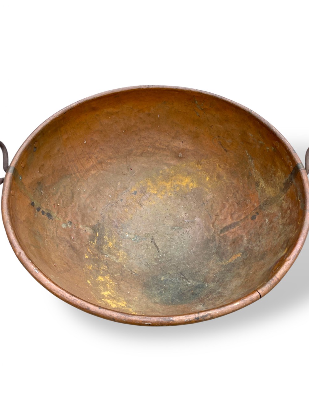 A large nineteenth-century hand-hammered copper bowl with rolled rim edges and two side loop handles. View IV